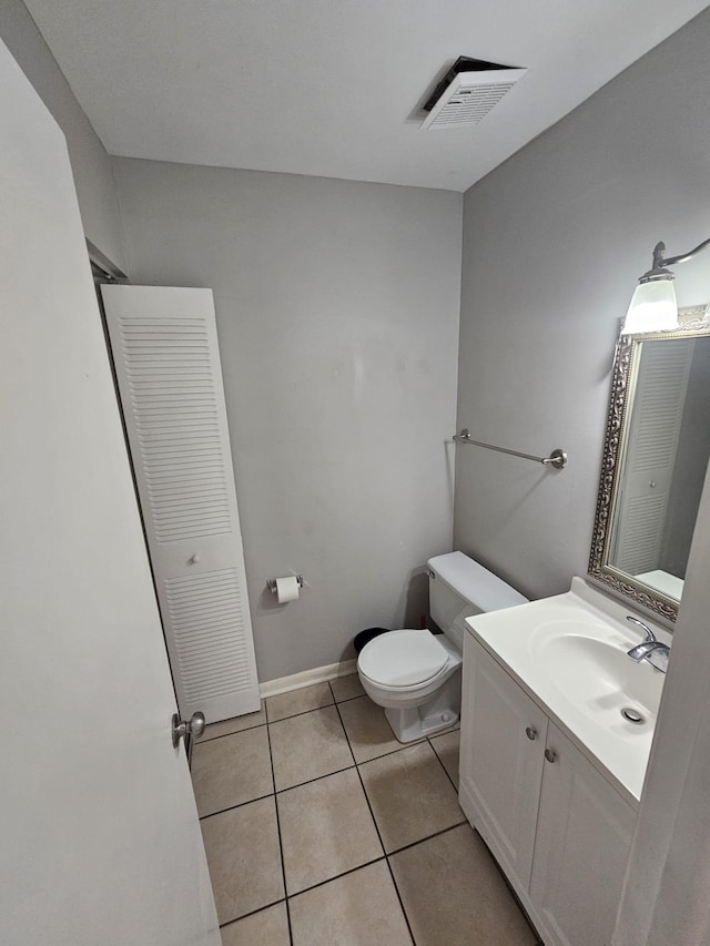 bathroom featuring vanity, toilet, and tile patterned flooring