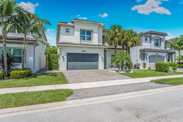 view of front of house with a front yard and a garage