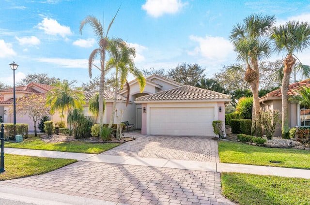 view of front of house with a front yard and a garage