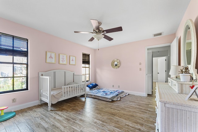 bedroom with ceiling fan and light hardwood / wood-style flooring