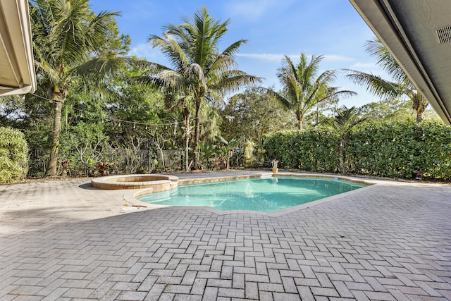 view of pool featuring an in ground hot tub and a patio