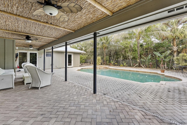 view of swimming pool with ceiling fan and a patio area