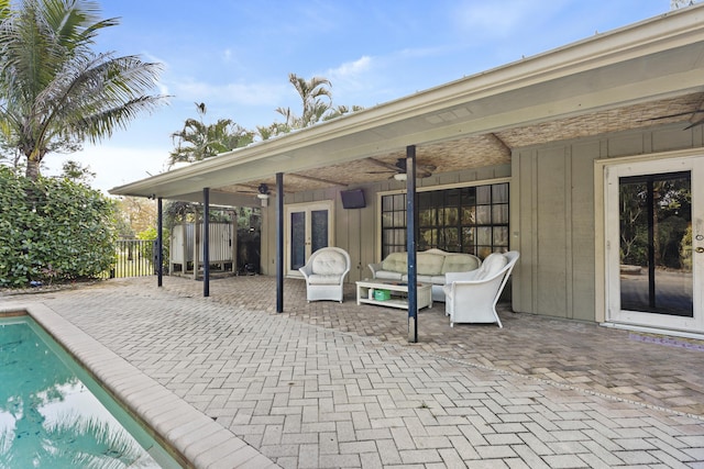 view of patio / terrace featuring ceiling fan, a fenced in pool, and an outdoor hangout area