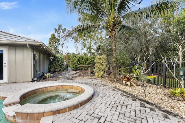 view of patio / terrace with an in ground hot tub