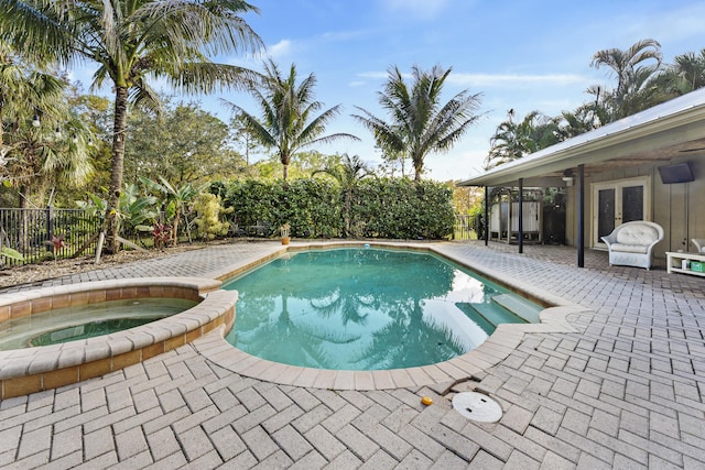 view of pool featuring an in ground hot tub, french doors, and a patio