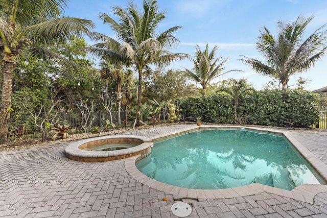 view of pool featuring an in ground hot tub