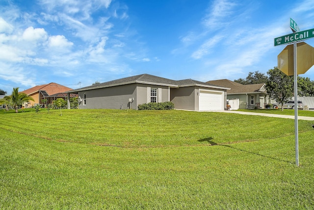 ranch-style home featuring a garage and a front yard