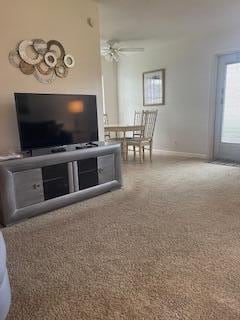 carpeted living room with ceiling fan