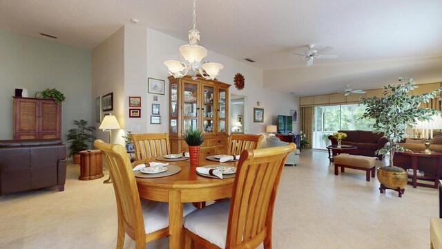 dining space with vaulted ceiling and ceiling fan with notable chandelier