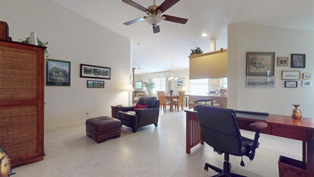 office space featuring light tile patterned flooring, high vaulted ceiling, and ceiling fan with notable chandelier