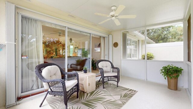 sunroom featuring ceiling fan