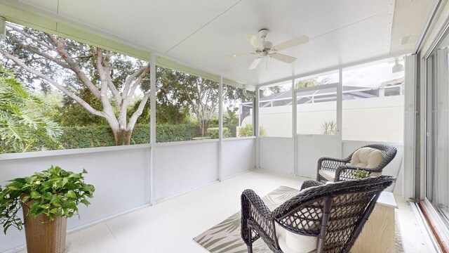 sunroom featuring ceiling fan