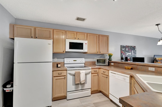 kitchen with white appliances, sink, light brown cabinets, kitchen peninsula, and hanging light fixtures