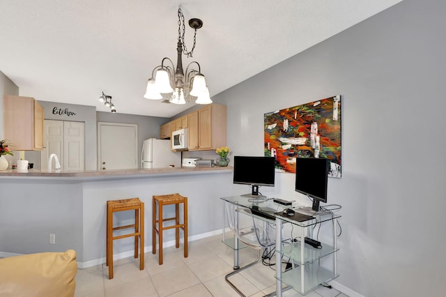 kitchen with kitchen peninsula, sink, white appliances, light brown cabinets, and pendant lighting