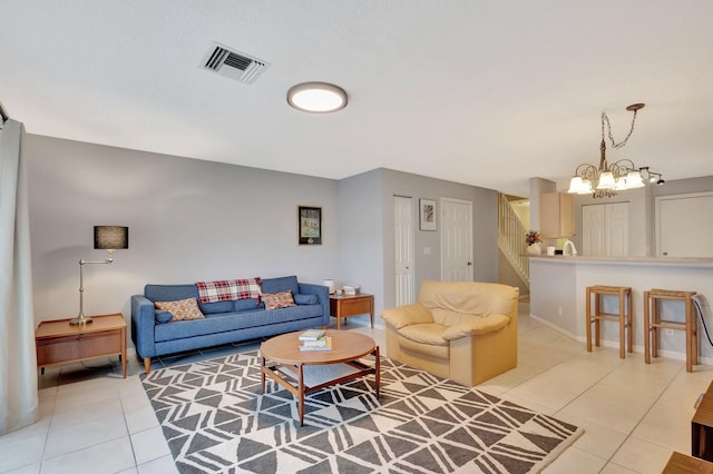 living room with a notable chandelier and light tile patterned floors