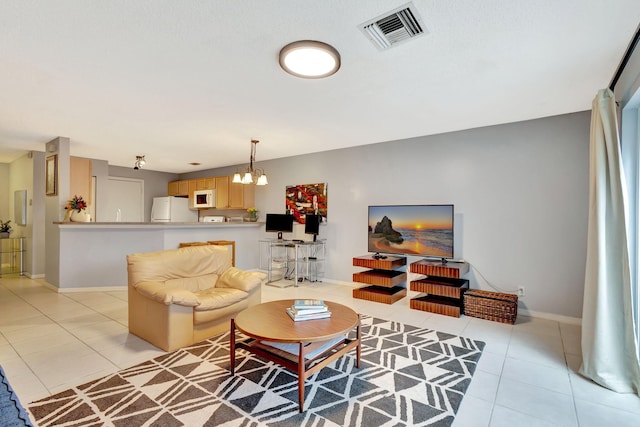 tiled living room with an inviting chandelier