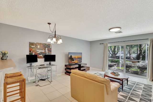 living room with light tile patterned floors, an inviting chandelier, and a textured ceiling