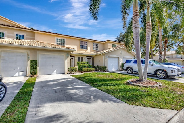 view of front of property with a front yard and a garage