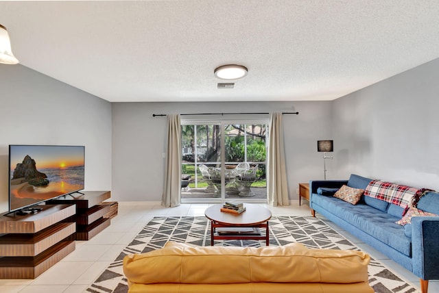 tiled living room featuring a textured ceiling