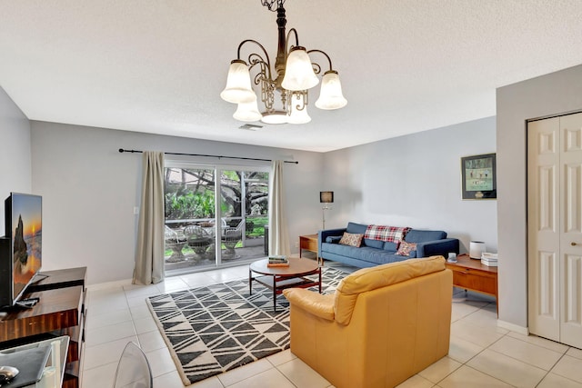 living room featuring an inviting chandelier, light tile patterned floors, and a textured ceiling