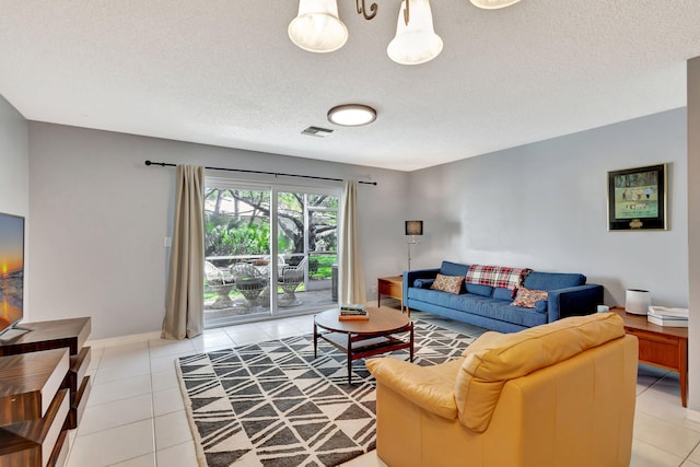 living room with light tile patterned floors and a textured ceiling