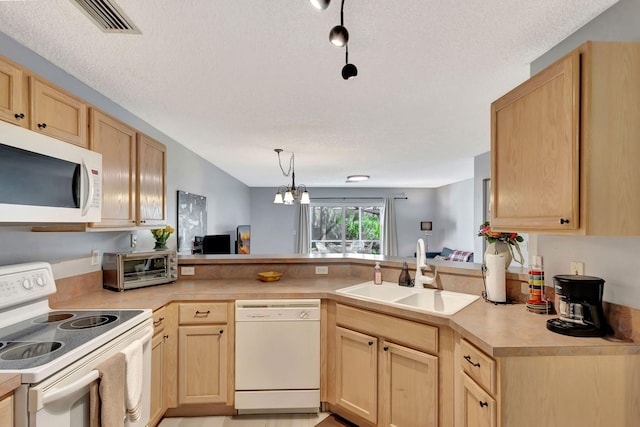 kitchen featuring sink, white appliances, and light brown cabinets