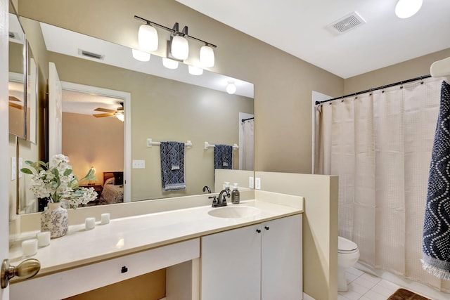 bathroom featuring tile patterned floors, toilet, vanity, and ceiling fan