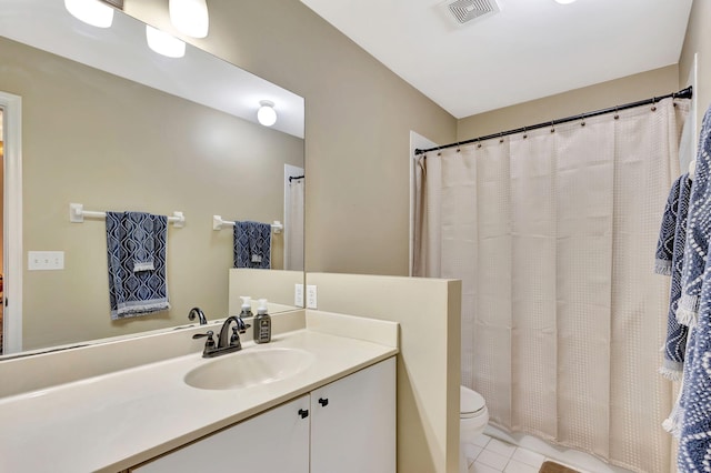 bathroom featuring toilet, tile patterned floors, and vanity