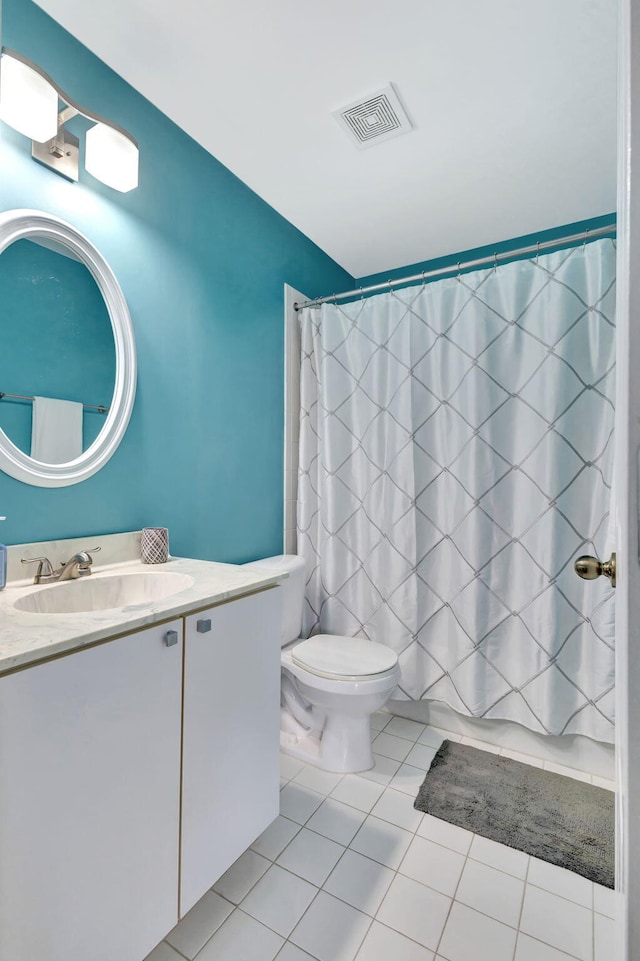 full bathroom featuring tile patterned floors, vanity, toilet, and shower / tub combo