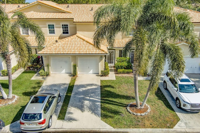 mediterranean / spanish-style house featuring a garage and a front lawn