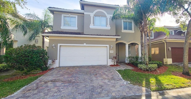 1098 Center Stone Ln, Riviera Beach, FL 33404 - mediterranean / spanish house featuring a garage