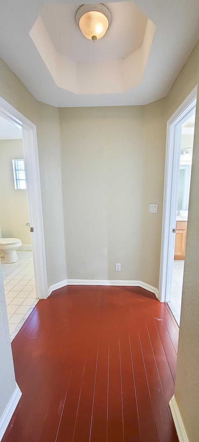 spare room featuring hardwood / wood-style flooring and a tray ceiling