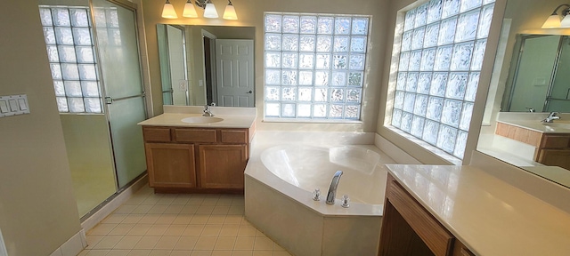 bathroom with tile patterned flooring, vanity, and separate shower and tub