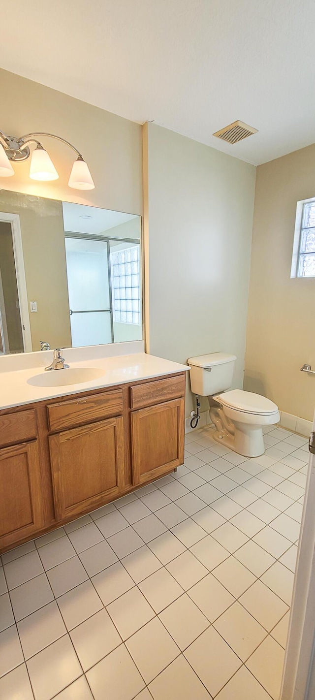 bathroom with tile patterned floors, vanity, and toilet