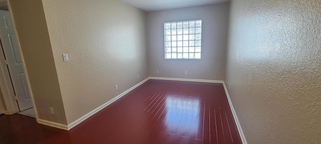 empty room featuring wood-type flooring