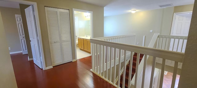 hallway with hardwood / wood-style floors