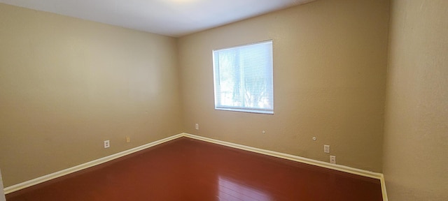 spare room with hardwood / wood-style flooring