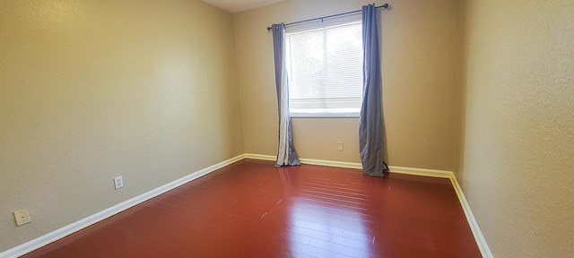 spare room featuring dark hardwood / wood-style floors