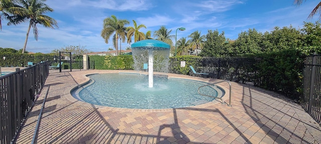 view of pool with pool water feature and a patio area