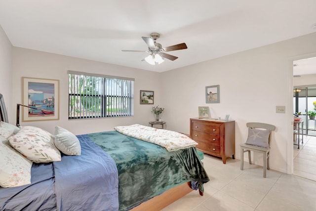 bedroom featuring multiple windows, ceiling fan, and light tile patterned floors