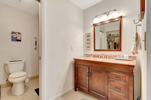 bathroom featuring vanity, toilet, and tile patterned floors