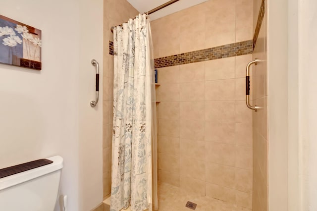 bathroom featuring toilet and walk in shower