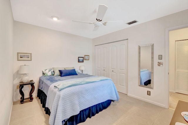 tiled bedroom with ceiling fan and a closet