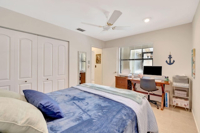 tiled bedroom with ceiling fan and a closet