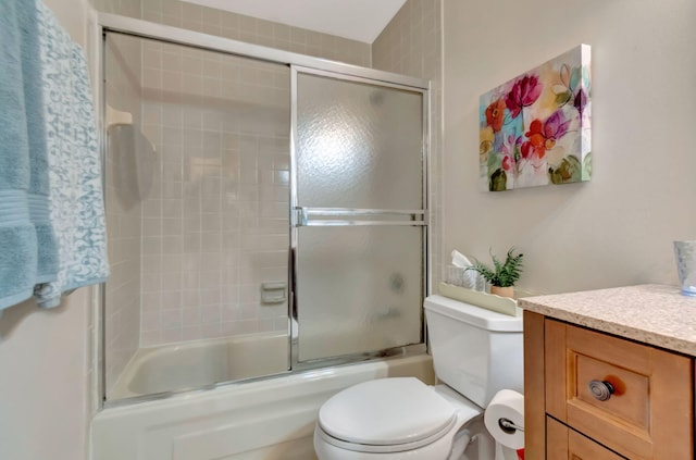 full bathroom with vanity, toilet, and bath / shower combo with glass door