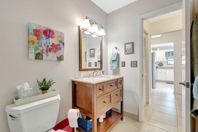 bathroom featuring vanity, toilet, and tile patterned flooring