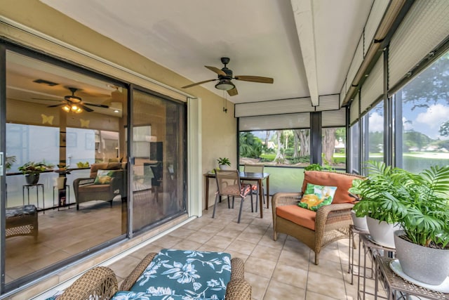 sunroom / solarium featuring ceiling fan