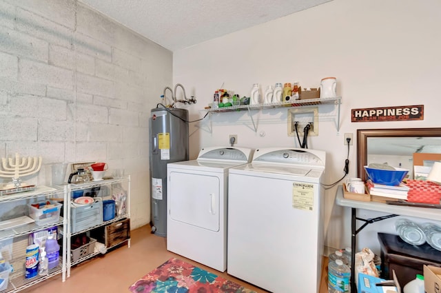 laundry area featuring a textured ceiling, washer and dryer, and electric water heater