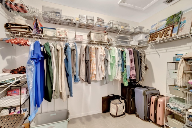 walk in closet featuring light tile patterned flooring