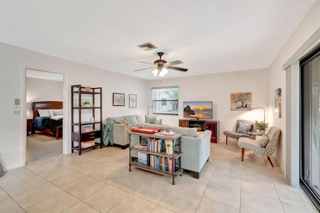 living room featuring light tile patterned flooring and ceiling fan